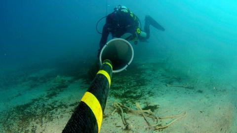 Cable submarino de fibra óptica y submarinista